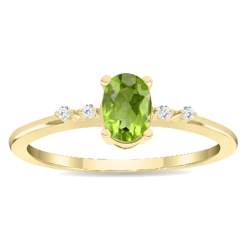 Gemstone rings perfect for teens with bold stones -Women's Oval Shaped Peridot and Diamond Sparkle Ring in 10K Yellow Gold