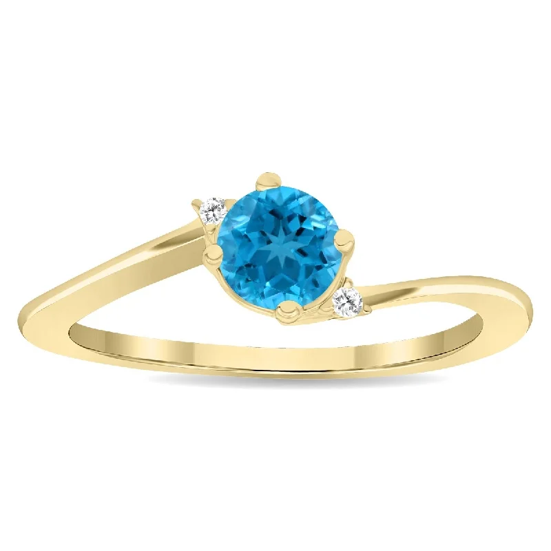 Gemstone rings with opal for shifting iridescent charm -Women's Round Shaped Blue Topaz and Diamond Wave Ring in 10K Yellow Gold